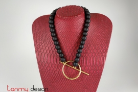 Necklace designed with round metal pendants, black wood beads